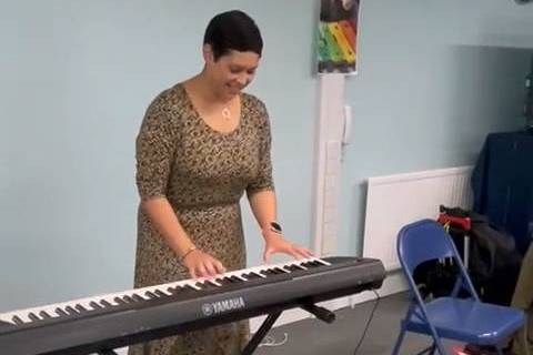 Music Therapist Gemma Lenton-Smith playing piano